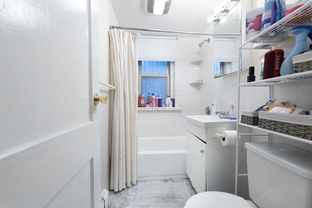 12 Ransom Road, Unit 16 Boston, MA 02135 - Photo 13 of 17 a bathroom with a sink toilet vanity and tub