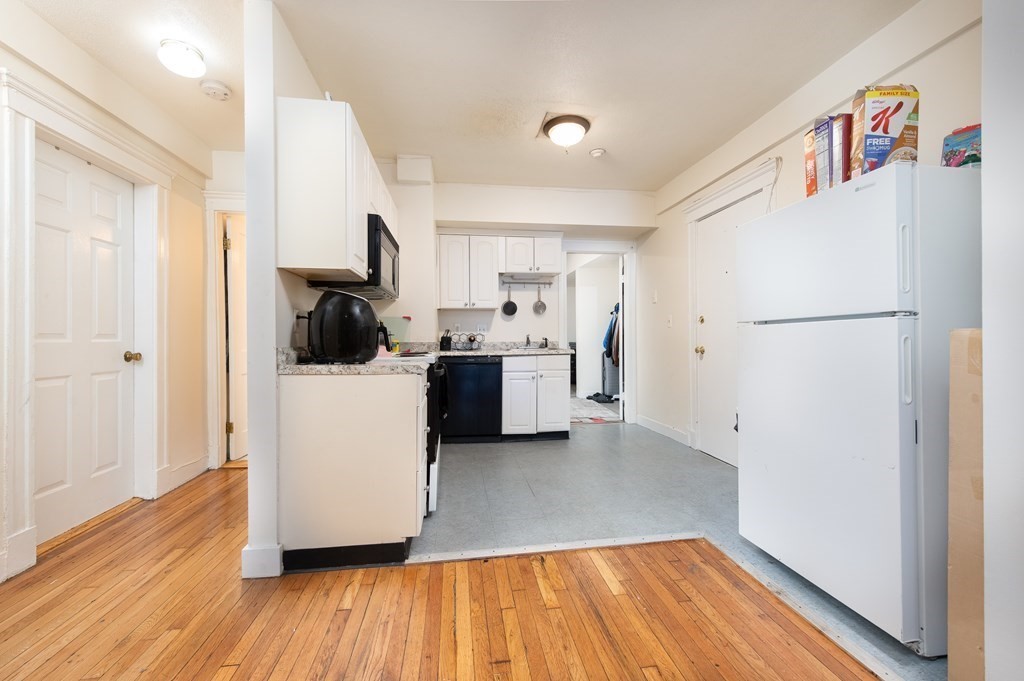 12 Ransom Road, Unit 16 Boston, MA 02135 - Photo 2 of 17 a view of a kitchen with a sink dishwasher and a refrigerator