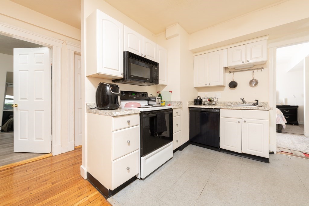 12 Ransom Road, Unit 16 Boston, MA 02135 - Photo 3 of 17 a view kitchen with white cabinets and white appliances