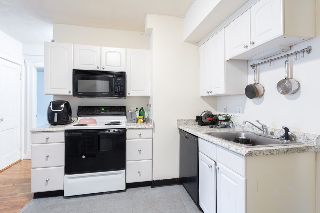 12 Ransom Road, Unit 16 Boston, MA 02135 - Photo 4 of 17 a kitchen with a sink stove and microwave