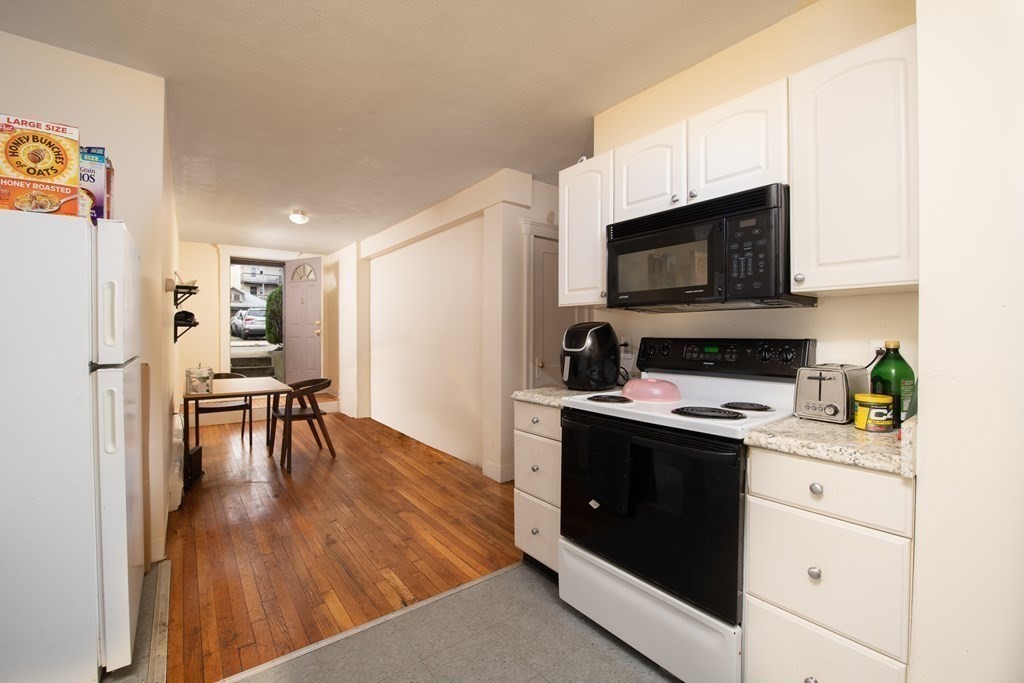 12 Ransom Road, Unit 16 Boston, MA 02135 - Photo 5 of 17 a kitchen with a stove and a microwave