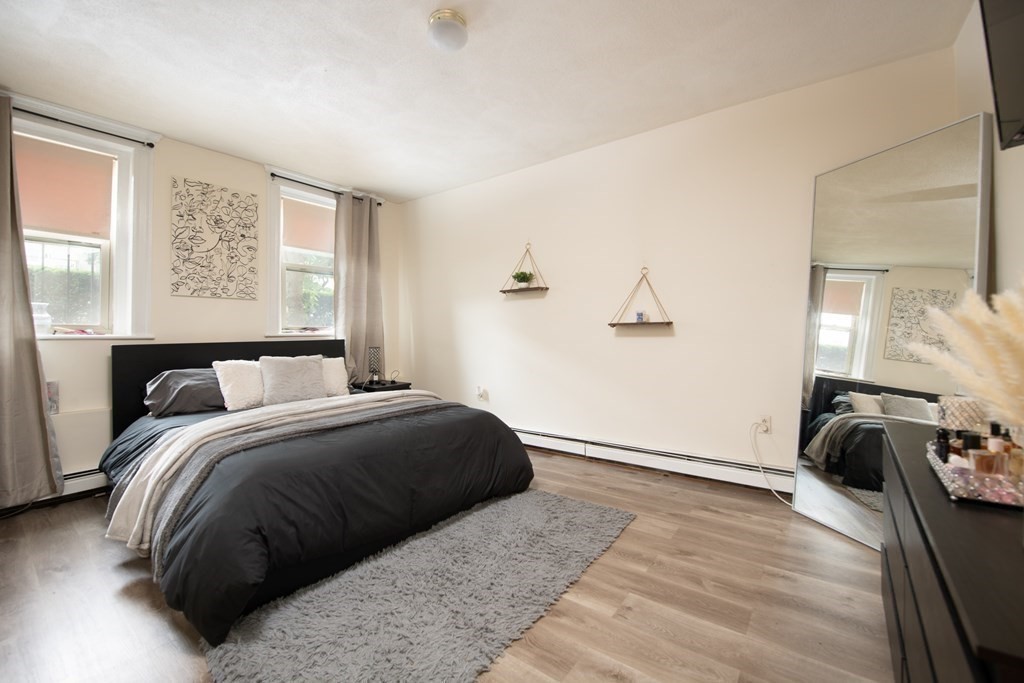 12 Ransom Road, Unit 16 Boston, MA 02135 - Photo 6 of 17 a bedroom with a bed and wooden floor