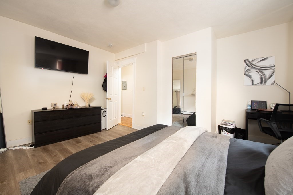 12 Ransom Road, Unit 16 Boston, MA 02135 - Photo 8 of 17 a bedroom with a bed and a flat screen tv