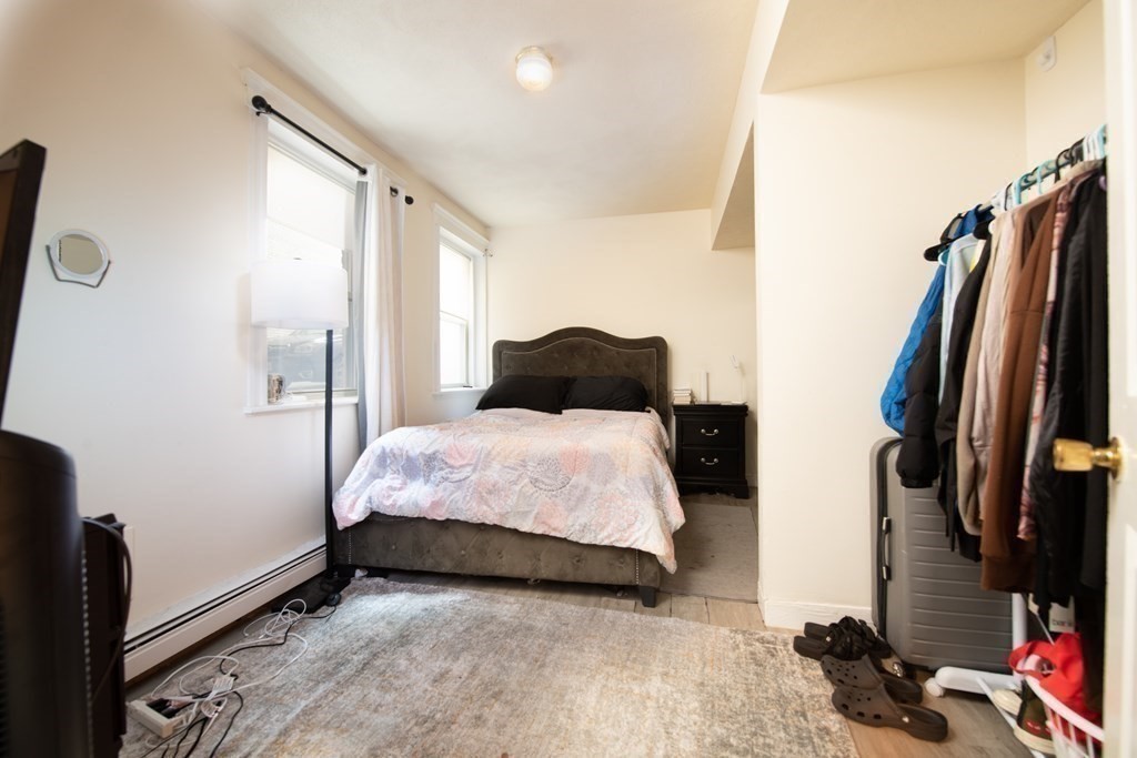 12 Ransom Road, Unit 16 Boston, MA 02135 - Photo 9 of 17 a bedroom with a bed closet and a mirror