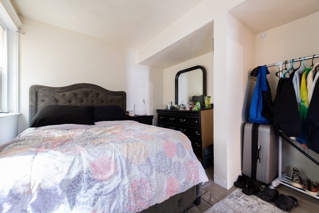 12 Ransom Road, Unit 16 Boston, MA 02135 - Photo 10 of 17 a bedroom with a bed and a flat tv screen on dresser