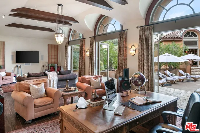 a living room with furniture fireplace and wooden floor
