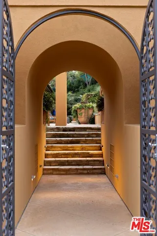 a view of a house with swimming pool and sitting area