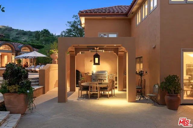 a backyard of a house with table and chairs