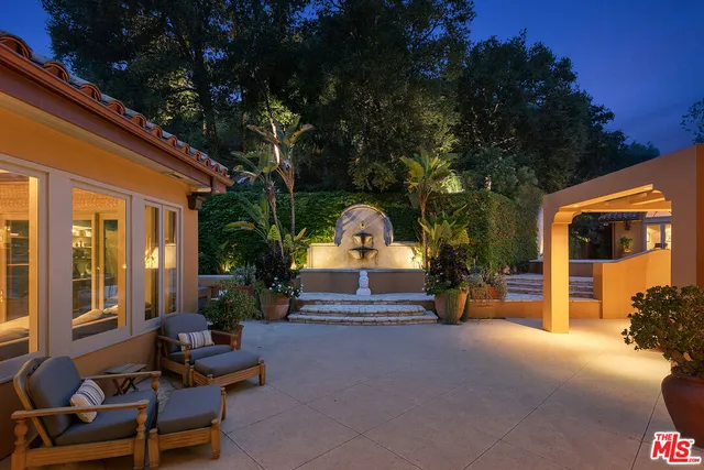 a view of a house with large windows and a fireplace
