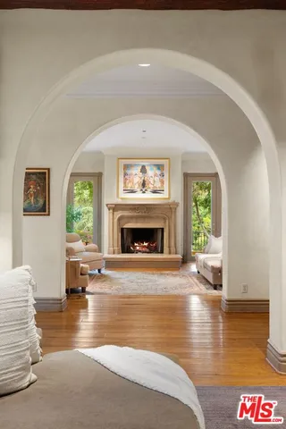 a living room with furniture fireplace and window