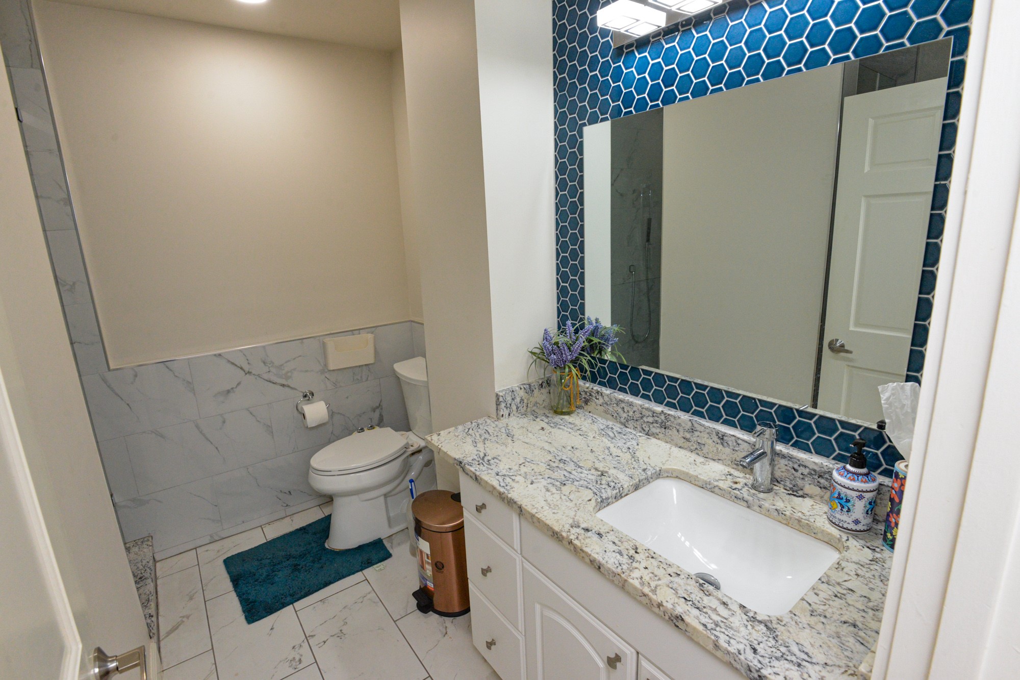 10710 D-K Ranch Road Austin, TX 78759 - Photo 16 of 34 A well-appointed bathroom features a single vanity with stone counters and a toilet, all illuminated by recessed lighting.