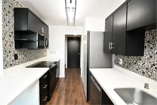 a kitchen with a sink stove and refrigerator