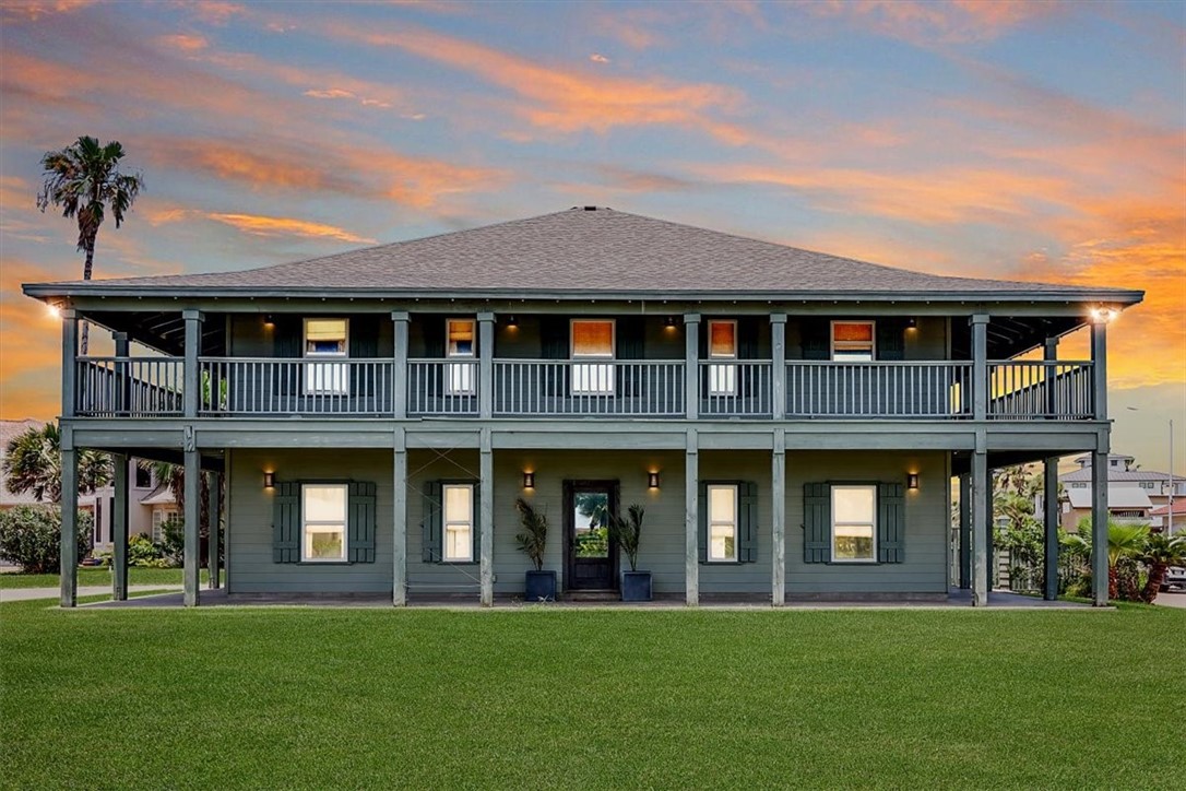 a front view of brick house with a yard