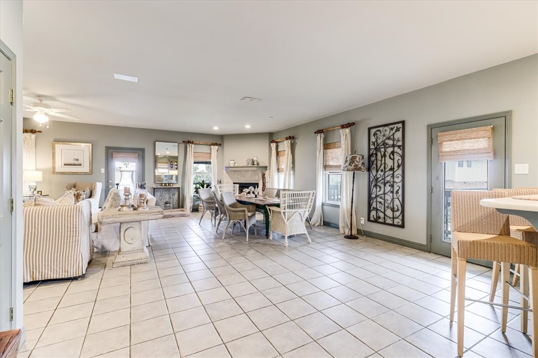 488 Margo Lane Port Aransas, TX 78373 - Photo 11 of 40 a living room with furniture and a dining table next to a window