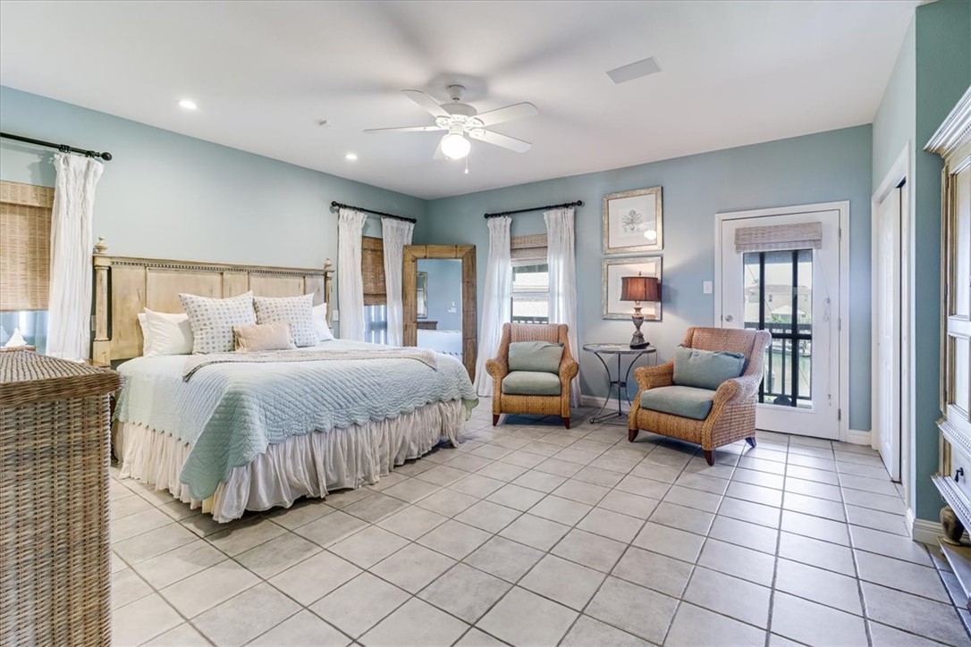 488 Margo Lane Port Aransas, TX 78373 - Photo 18 of 40 a spacious bedroom with a bed and window