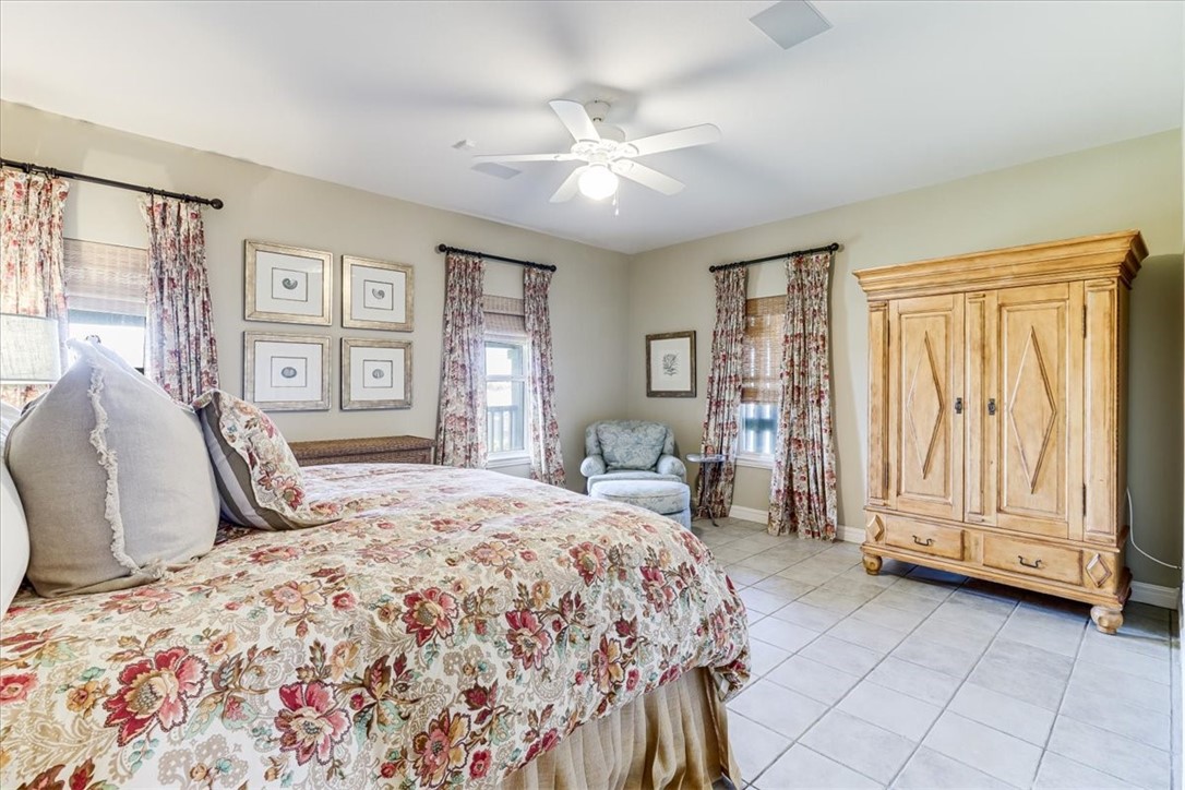 488 Margo Lane Port Aransas, TX 78373 - Photo 21 of 40 a bedroom with a large bed and a window