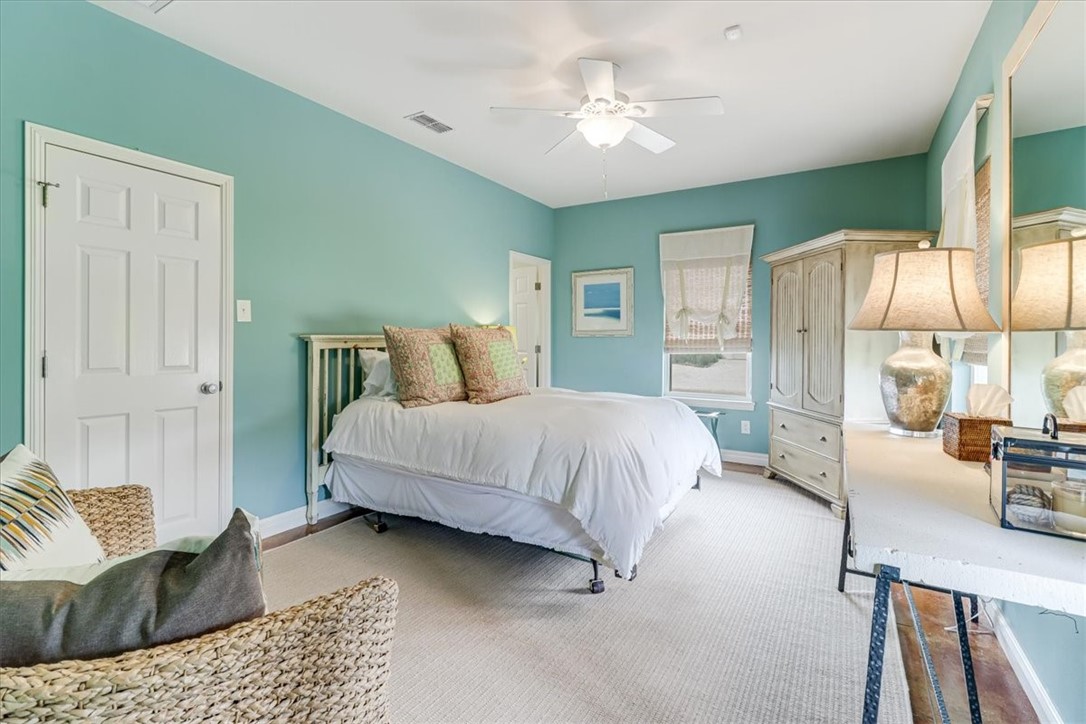 488 Margo Lane Port Aransas, TX 78373 - Photo 30 of 40 a spacious bedroom with a bed a couch and dresser