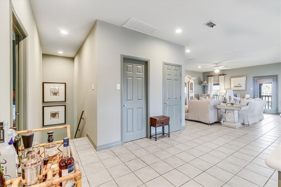 488 Margo Lane Port Aransas, TX 78373 - Photo 6 of 40 a spacious bedroom with a bed and furniture