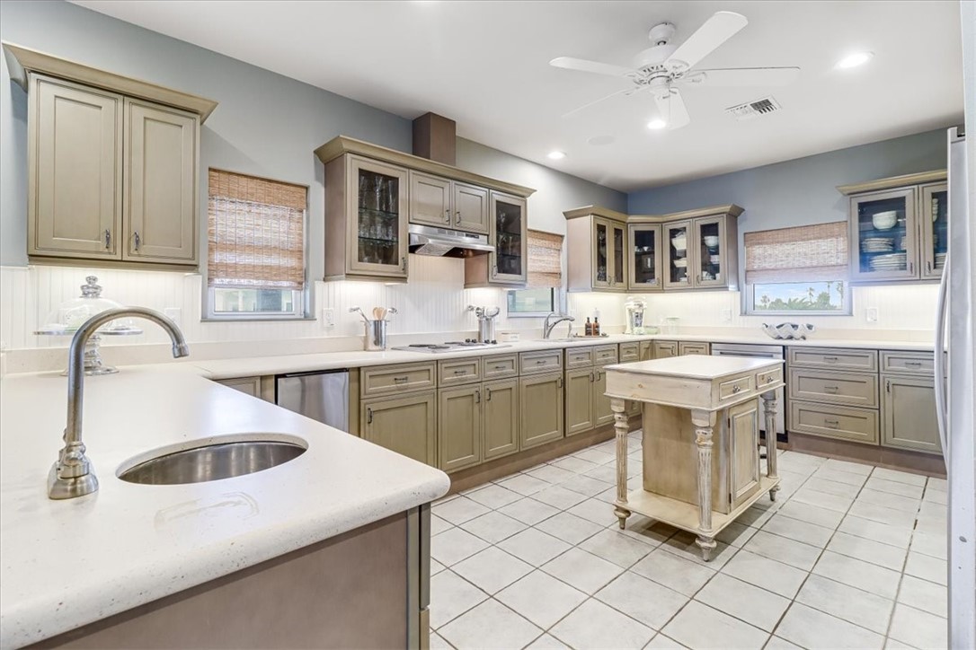 488 Margo Lane Port Aransas, TX 78373 - Photo 7 of 40 a kitchen with a sink stove and cabinets