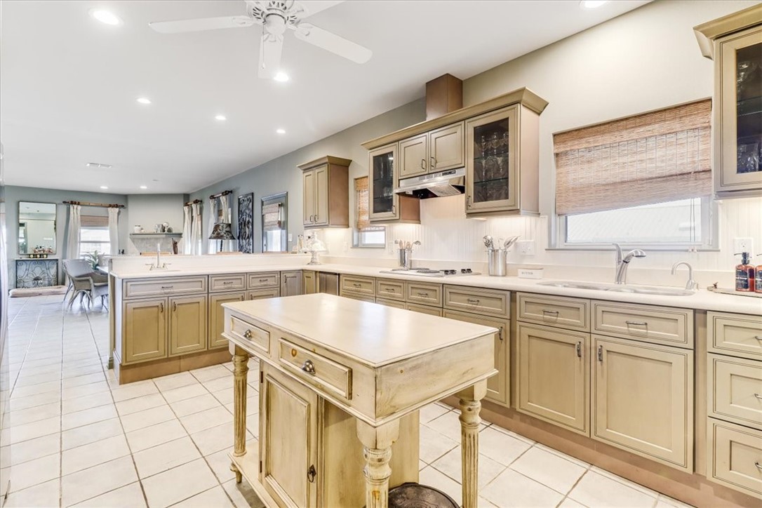 488 Margo Lane Port Aransas, TX 78373 - Photo 8 of 40 a kitchen with a sink window and cabinets