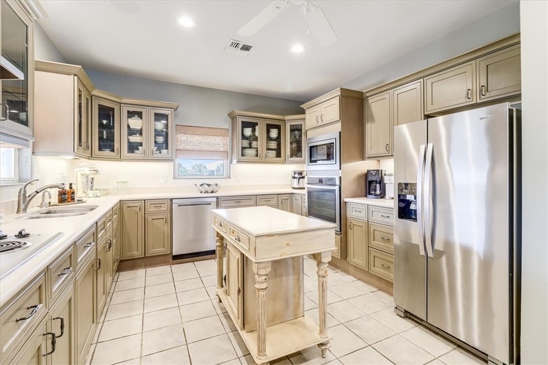 488 Margo Lane Port Aransas, TX 78373 - Photo 9 of 40 a kitchen with a refrigerator a sink and dishwasher