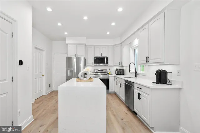 a kitchen with a sink a stove and a refrigerator