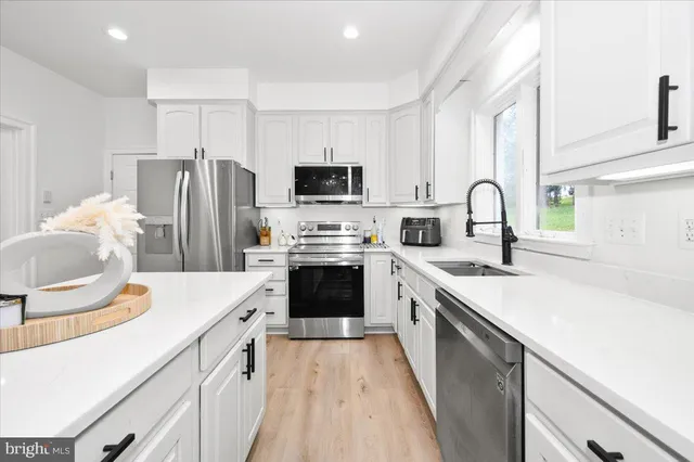 a kitchen with a sink stove and microwave