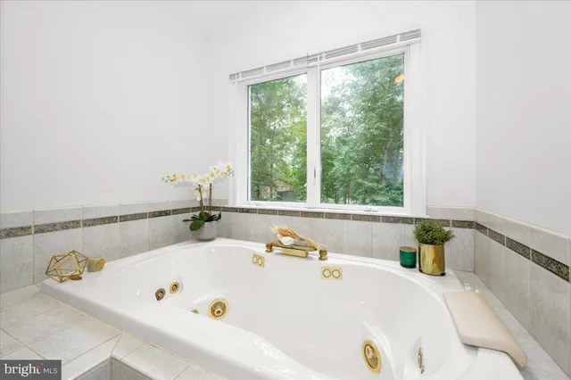 a bathroom with a granite countertop sink a toilet and a mirror