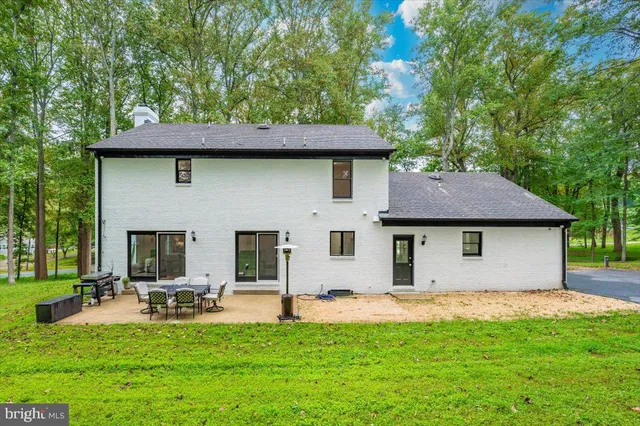 a view of a green field with trees in the background