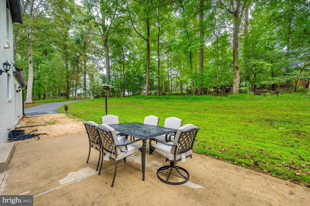 a view of a house with a yard and sitting area