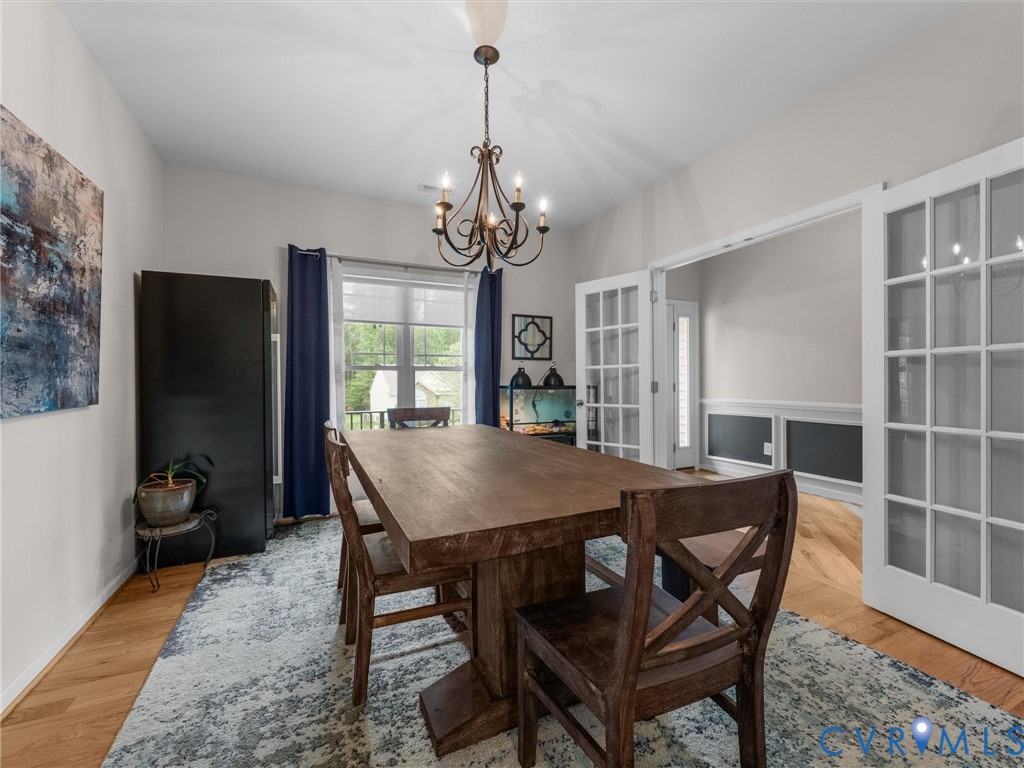 10824 Avening Road Chesterfield, VA 23832 - Photo 9 of 47 a dining room with furniture a chandelier and wooden floor