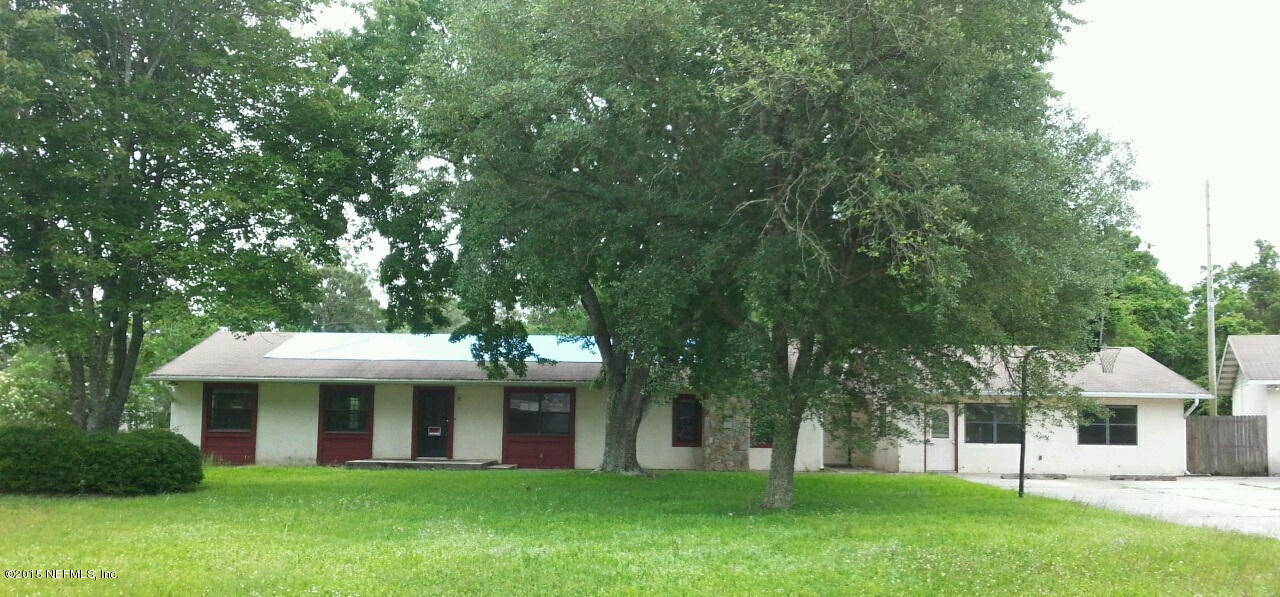 243 Dusty Road St. Augustine, FL 32095 - Photo 1 of 25 a view of a white house in front of a big yard with large trees