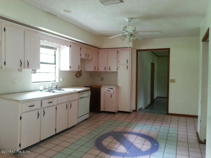 243 Dusty Road St. Augustine, FL 32095 - Photo 5 of 25 a kitchen with a sink cabinets and window