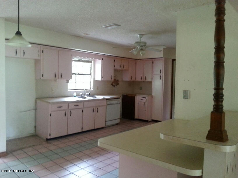 243 Dusty Road St. Augustine, FL 32095 - Photo 8 of 25 a kitchen with cabinets appliances and a window