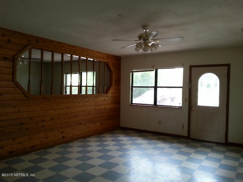 243 Dusty Road St. Augustine, FL 32095 - Photo 10 of 25 wooden floor in an empty room with a window