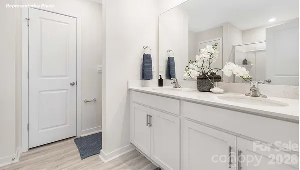 a bathroom with double vanity sink and a mirror