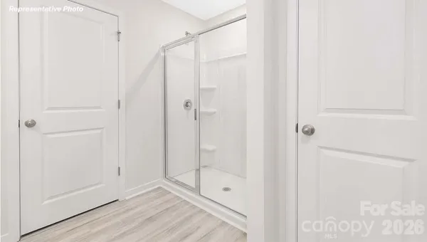 a bathroom with a shower and a glass door