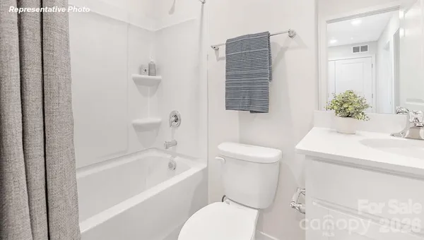 a living room with furniture and a lamp