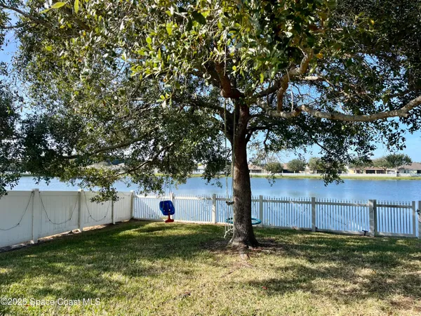 a backyard of a house with lots of plants and tree