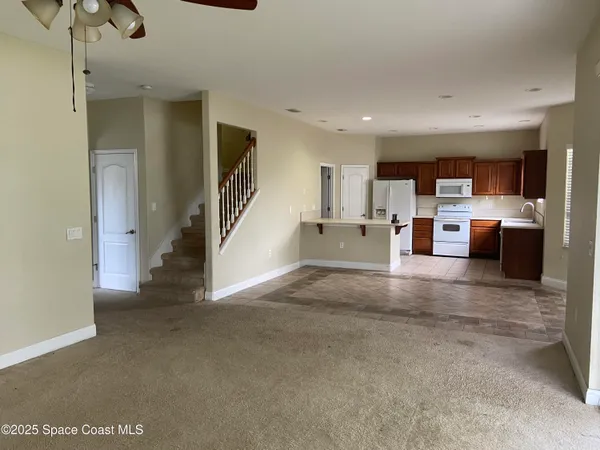 a view of living room filled with furniture and window