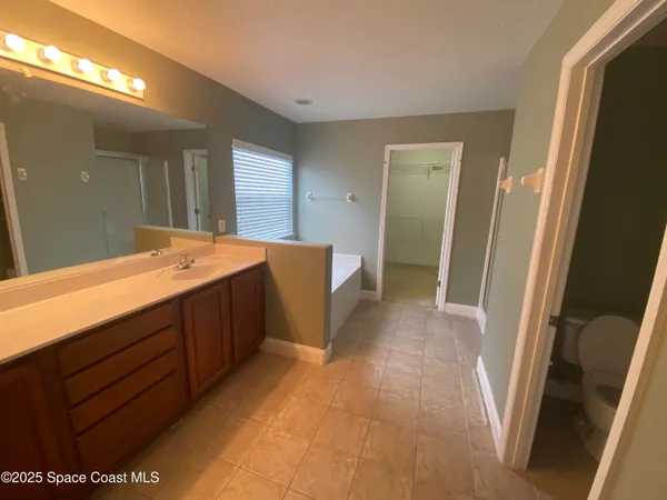 a bathroom with a sink a mirror and a shower