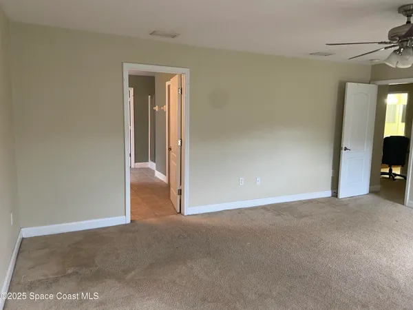 a view of an empty room with a mirror