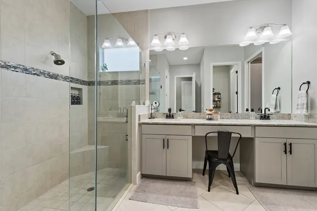 a bathroom with a shower sink and mirror