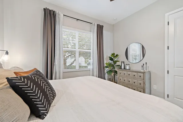 a bathroom with a granite countertop sink mirror vanity and toilet