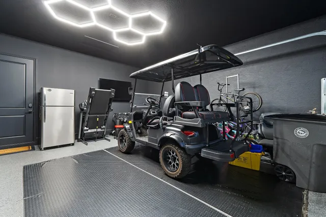 a living room with couch a flat screen tv and a floor to ceiling window