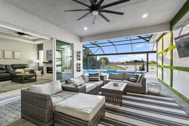 a view of swimming pool with seating space and wooden fence