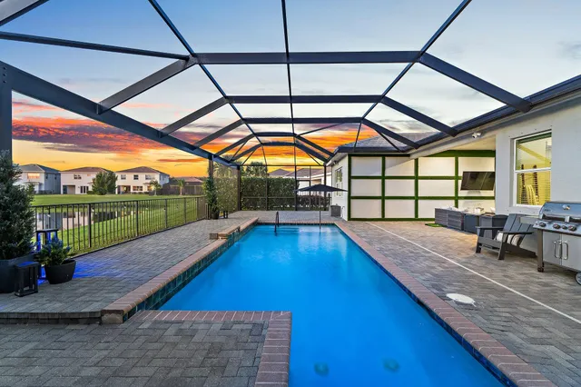 a view of a swimming pool and an outdoor seating