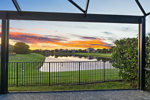 an aerial view of a house with a swimming pool yard and lake view