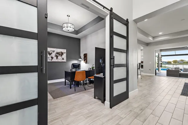 a view of a dining room with furniture and a chandelier