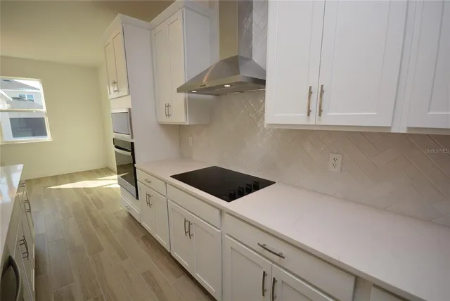 a kitchen with a cabinets and white appliances